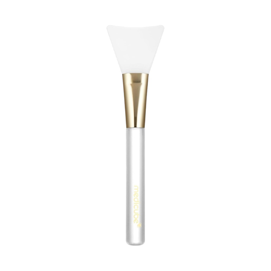 Medicube Jelly Brush aplicador facial de silicona blanco y dorado